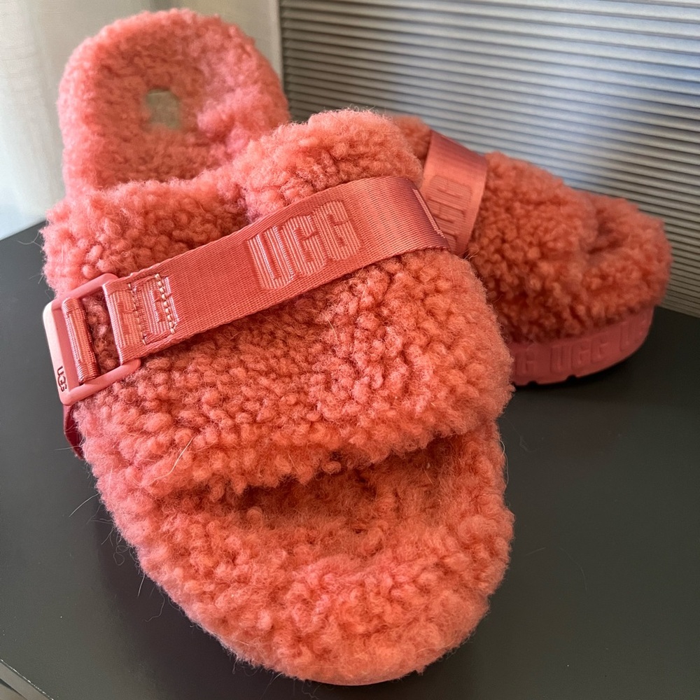 Pink Ugg shearling slippers.